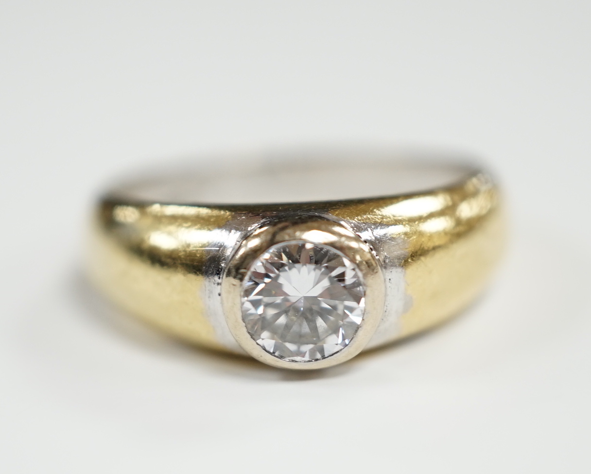 A modern 18ct gold and collet set solitaire diamond ring, size N, gross weight 7.6 grams, the stone weighing approx. 0.55ct.